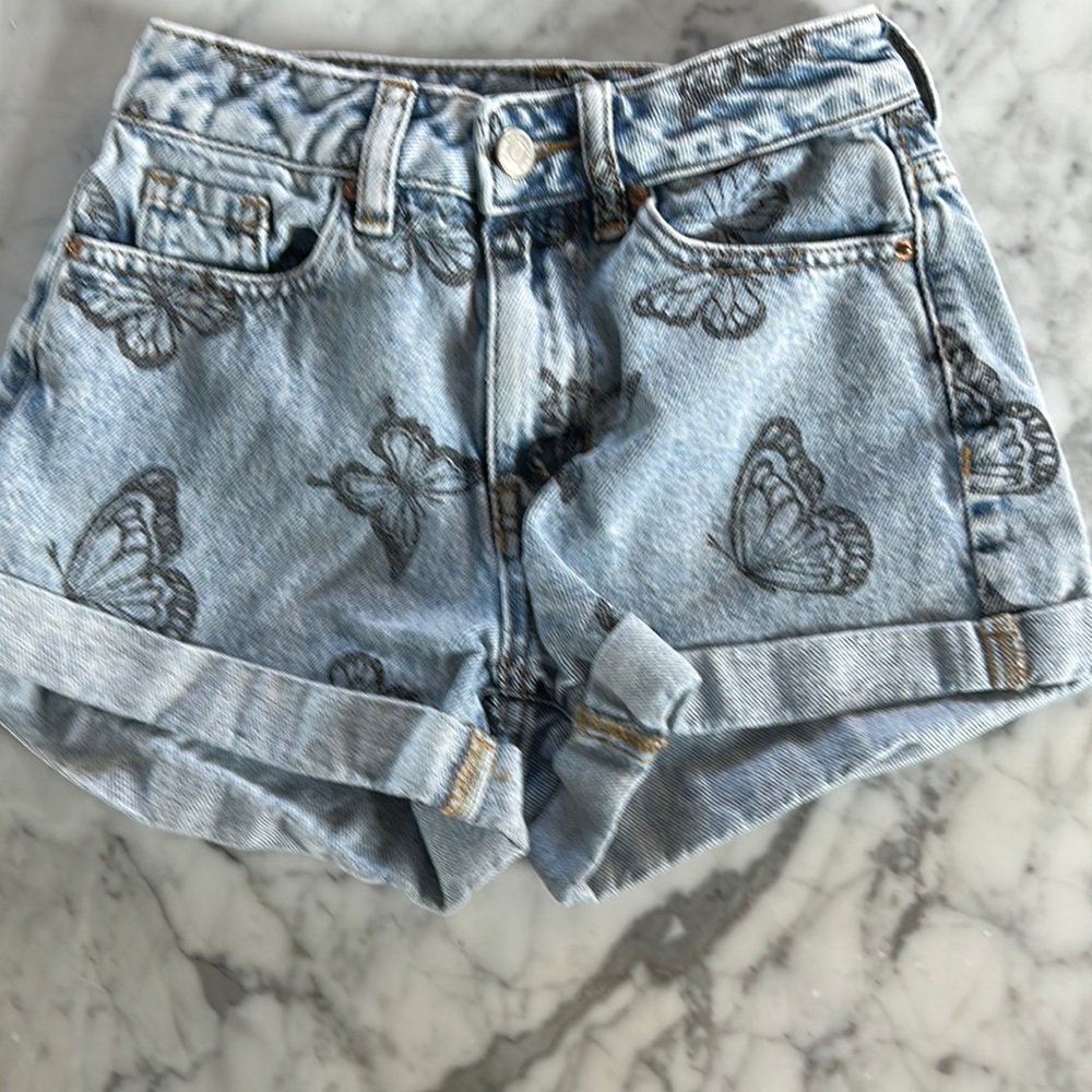 Blue denim butterfly jean shorts.